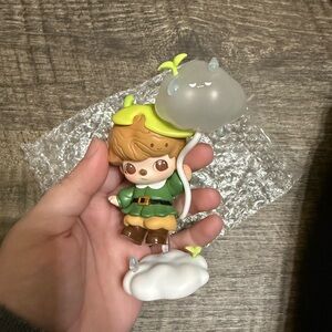 Cute Figurine with Green Outfit and Cloud Accessory